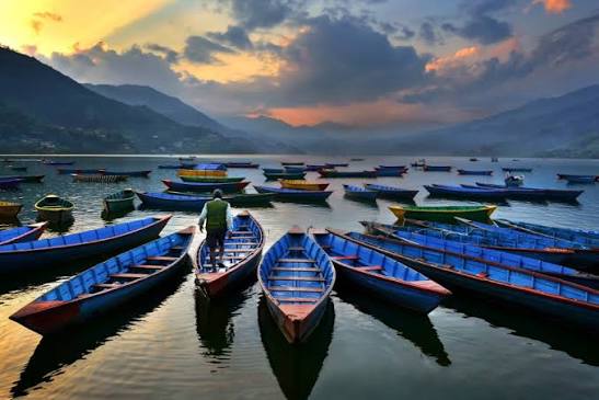 Wooden boats moored on Phewa Lake at Pokhara Lakeside, Nepal